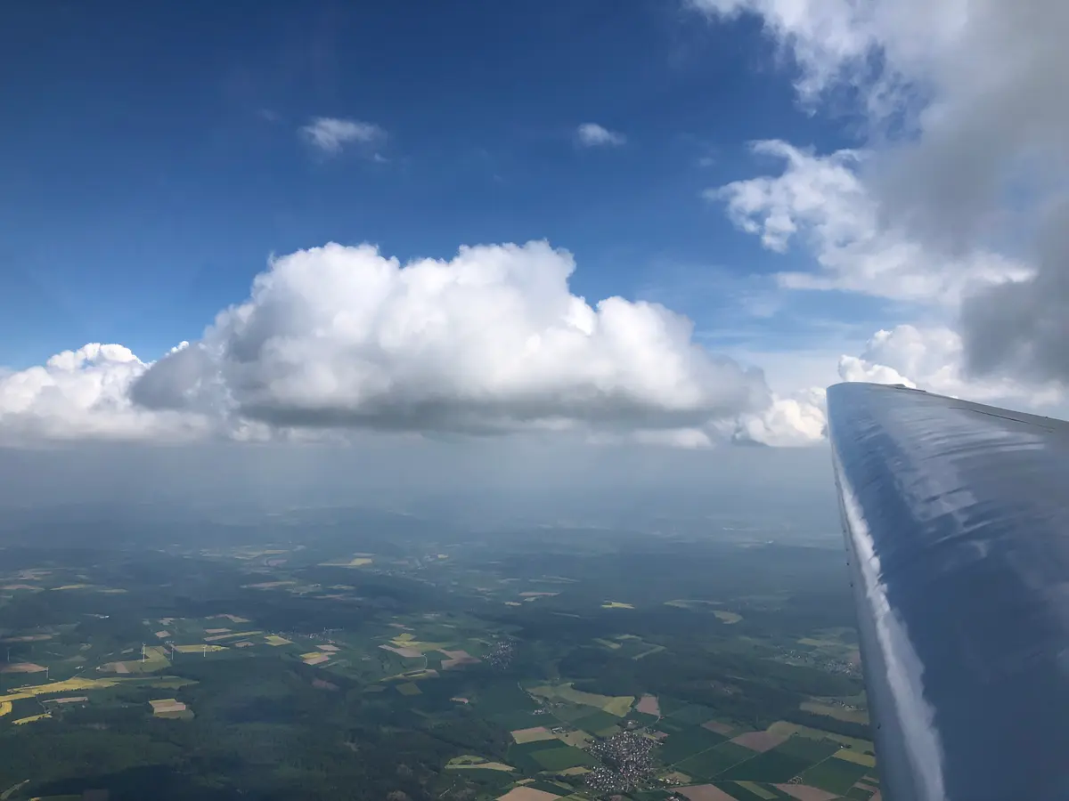 Blick aus dem Segelflugzeug: Tragfläche über Wolken und dem Weserbergland